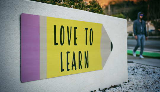 A wall with a sign saying 'love to learn'